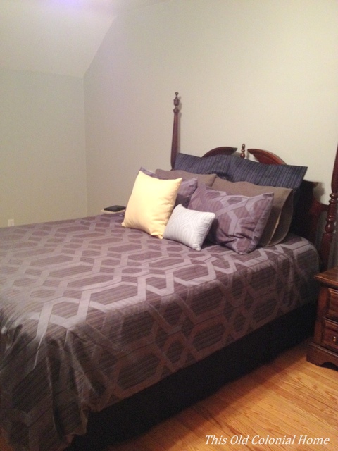 Gray walls with dark blue comforter 