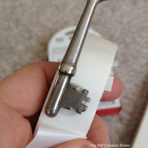 Use craft glue dots to adhere keys to backing