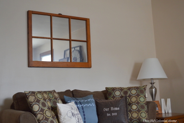 6-pane window mirror above couch 
