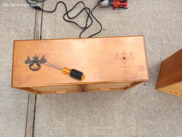 Unscrewing hardware from drawer