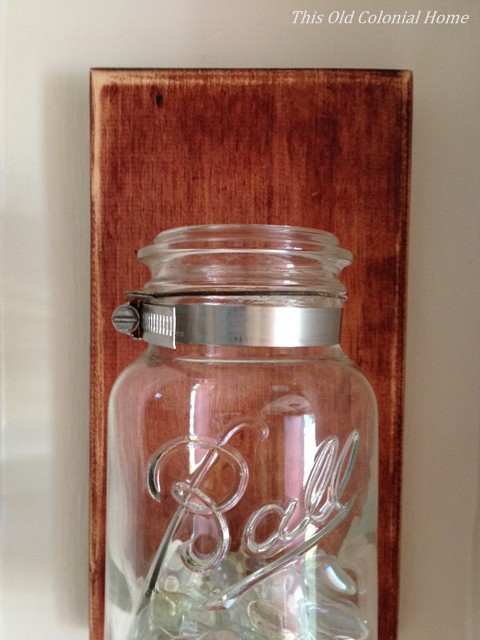 Attach mason jar to wood with pipe clamp