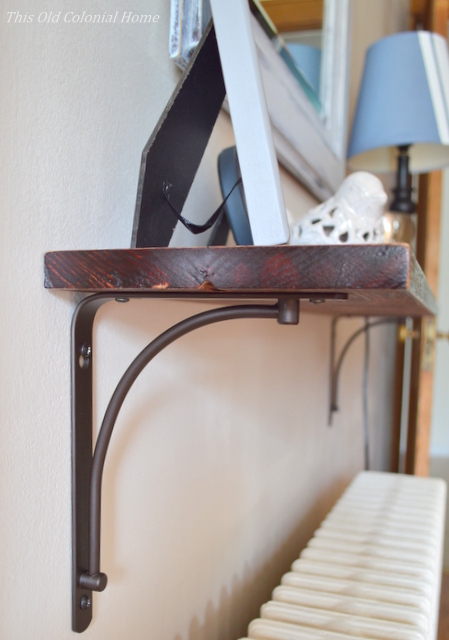 Wood shelf attached to wall with brackets