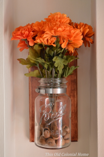 Mason jar with acorn filler and mums