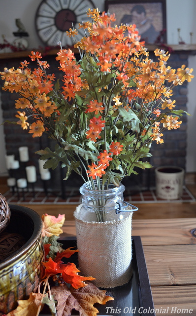Decorate a mason jar with burlap for fall