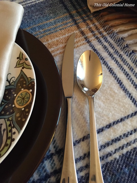 Brown, green, and blue dinner plates with flatware 