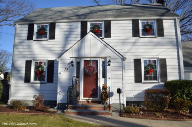 Christmas wreaths displayed in house windows